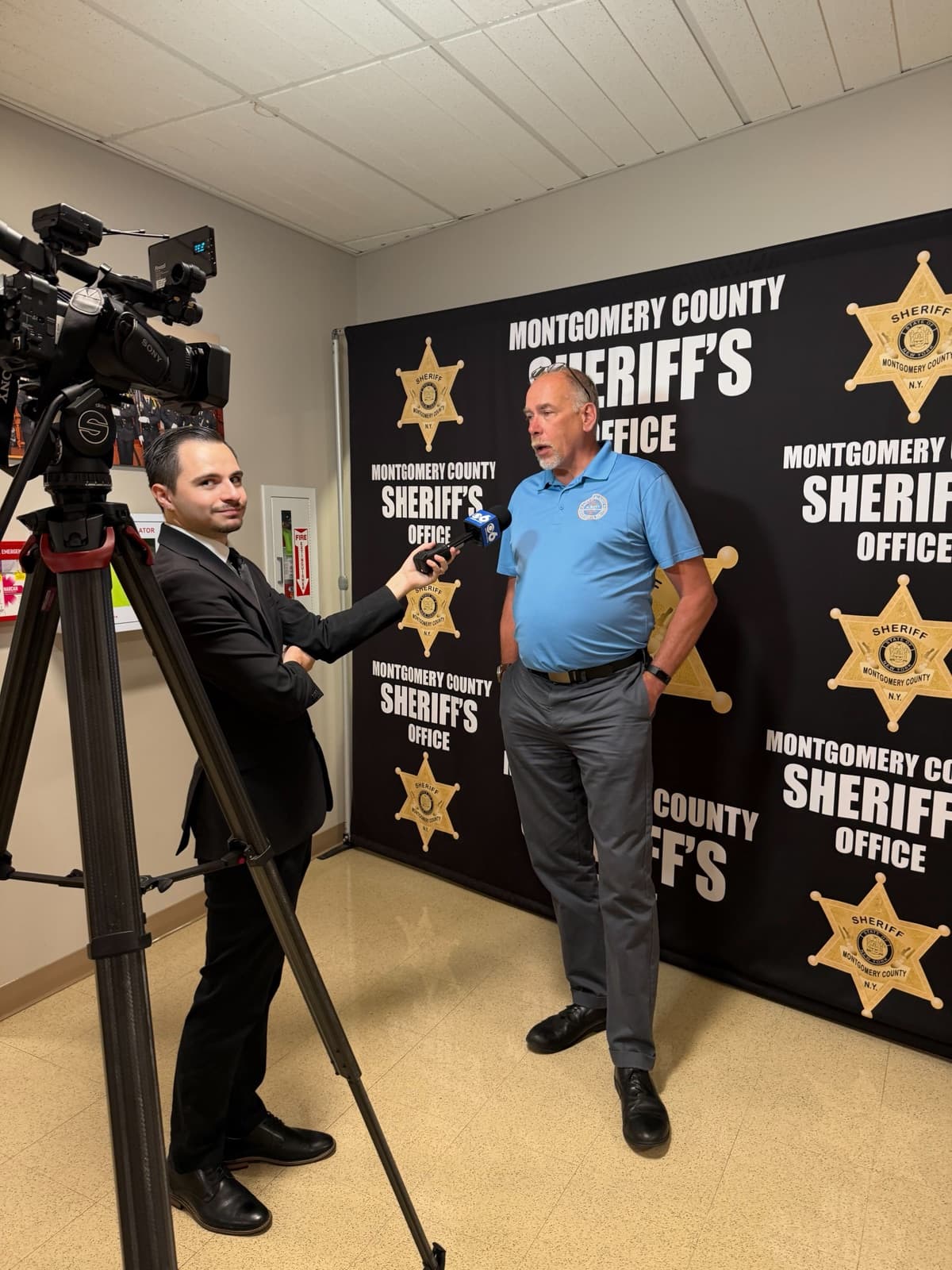 A CBS 6 reporter interviewing a summit attendee in front of a Montgomery County Sheriff’s Office backdrop
